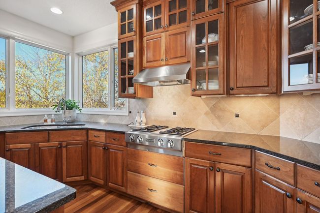 Large window over the sink looks out over the putting green and, beyond that, the pond. | Image 23