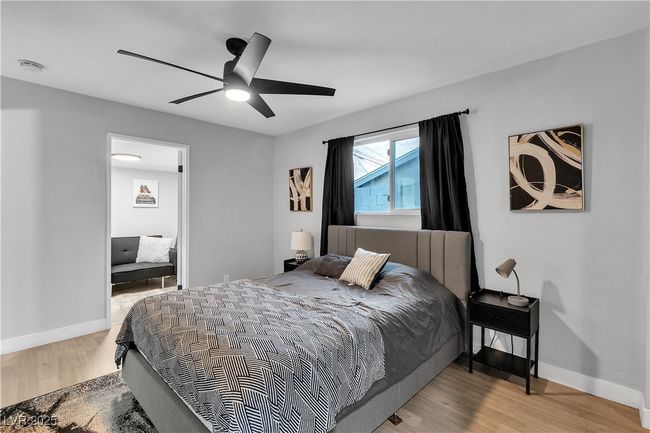 Bedroom featuring wood finished floors, ceiling fan, and baseboards | Image 32