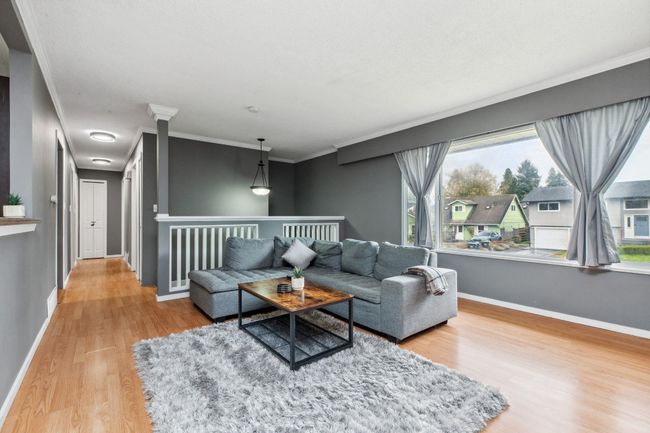 Living room featuring crown molding, wood finished floors, and baseboards | Image 6