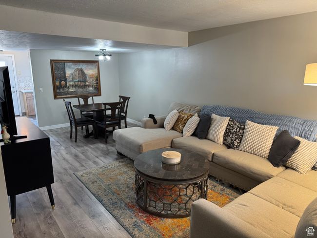 Living area featuring wood finished floors and baseboards | Image 6
