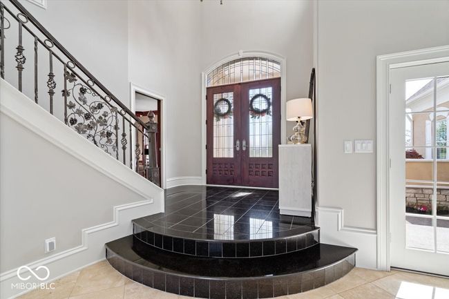The beautiful grand entry is enhanced by the elegant mahogany doors with leaded glass. | Image 8