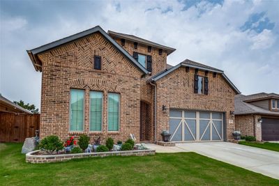 View of front featuring a garage and a front lawn | Image 2