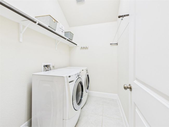 Laundry room featuring baseboards, independent washer and dryer, laundry area, and light tile patterned floors | Image 10