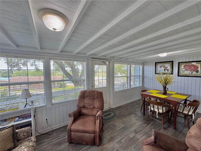 Front Florida room with a pull out couch for sleeping and chairs for sitting area and table/chairs eating area. Can be closed off for privacy. | Image 23