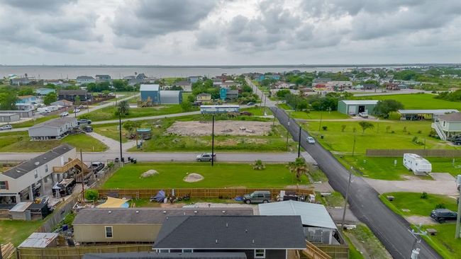 This perspective places the home within its broader environment, nestled among nearby lots and just a short distance from the sparkling bay. | Image 35