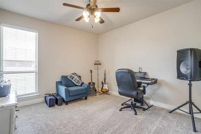 Carpeted home office featuring baseboards and a ceiling fan | Image 19