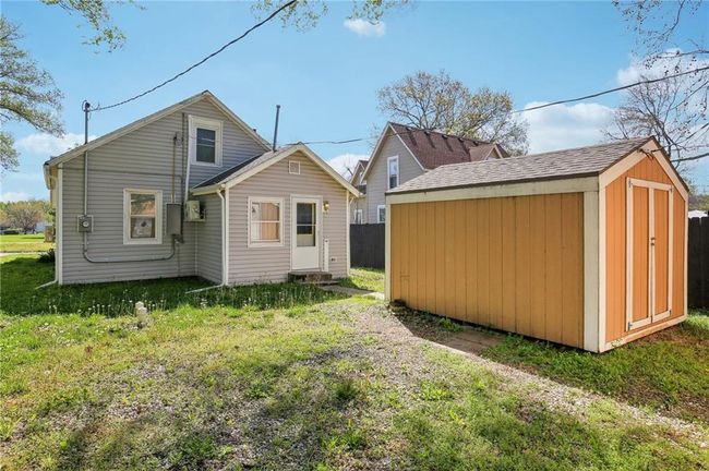Back of property featuring an outbuilding, a yard, and a storage unit | Image 25