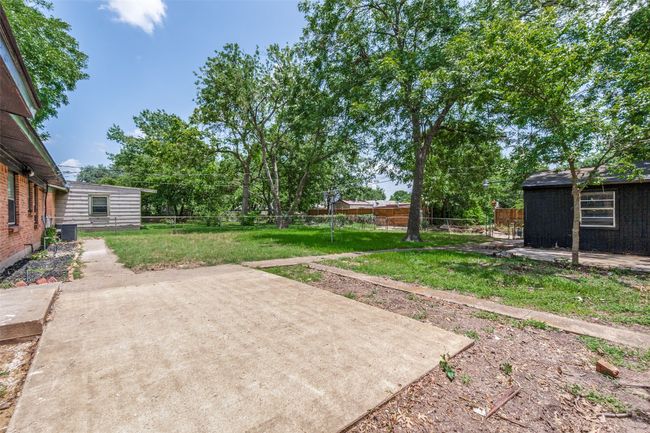 Fenced backyard with a patio area | Image 24