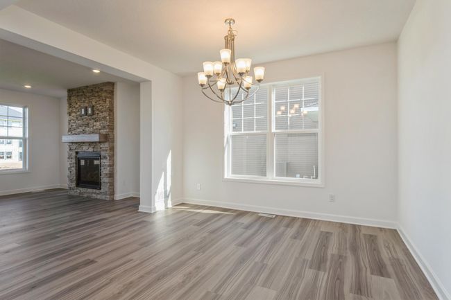 Photo is of the actual home. This formal dining area is large enough to comfortably accommodate a 10-seat dining room table. | Image 6