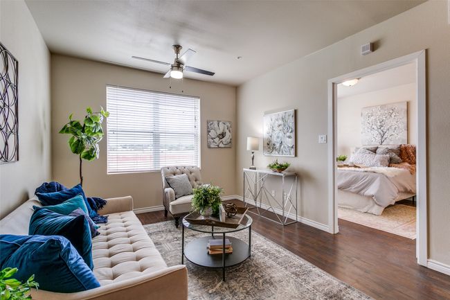 Living room with a ceiling fan and wood finished floors | Image 9