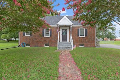 View of front facade with a front lawn | Image 1