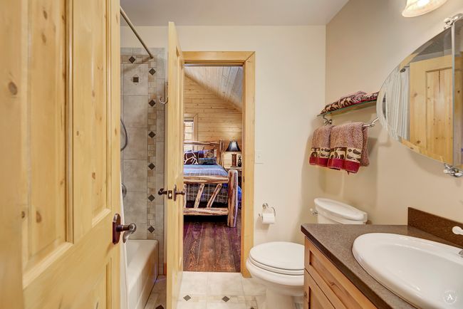 Ensuite bathroom with vanity, shower / bathtub combination, and tile patterned flooring | Image 27
