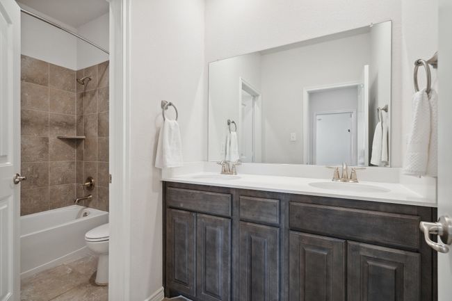 Full bath featuring double vanity and washtub / shower combination | Image 22