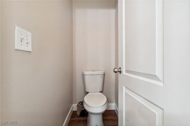 Bathroom featuring toilet, baseboards, and wood finished floors | Image 34