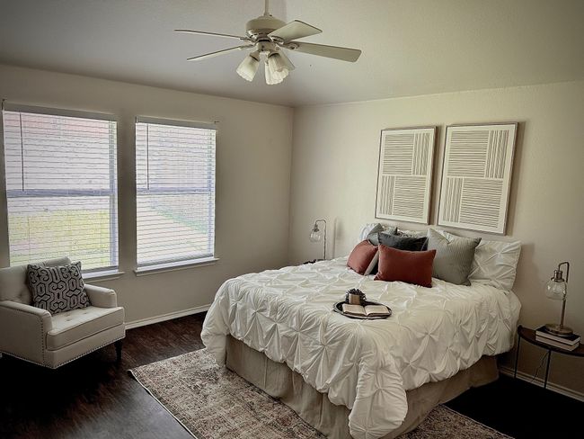 Bedroom with multiple windows, wood finished floors, and ceiling fan | Image 16