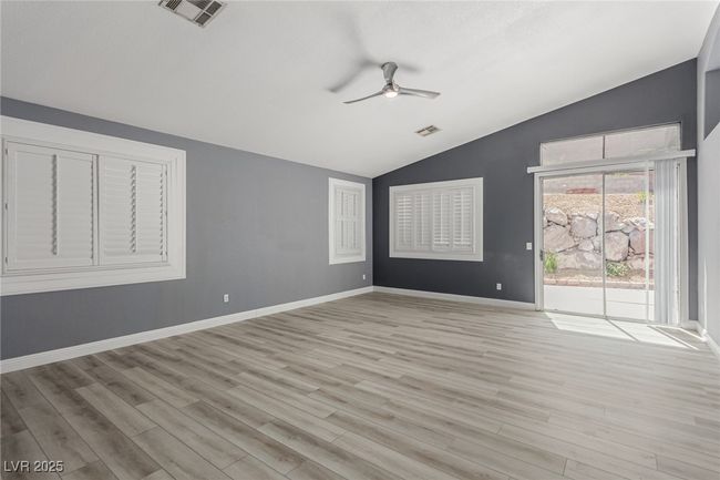 Great room with a ceiling fan, vaulted ceiling, and light wood-style floors | Image 4