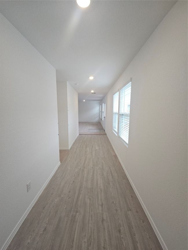 Hallway with wood finished floors and baseboards | Image 14