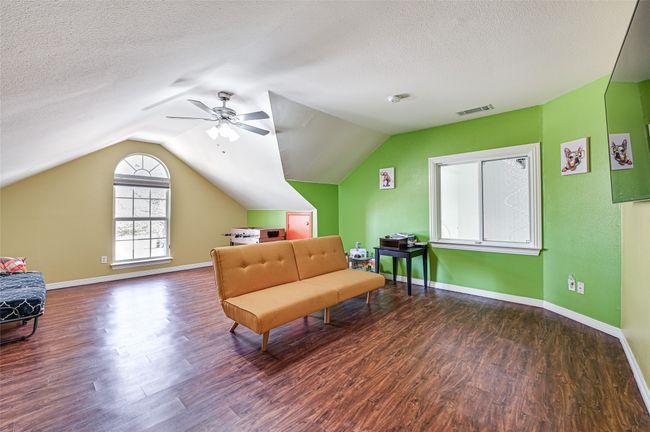 Sitting room featuring a textured ceiling, lofted ceiling, ceiling fan, and hardwood / wood-style floors | Image 13