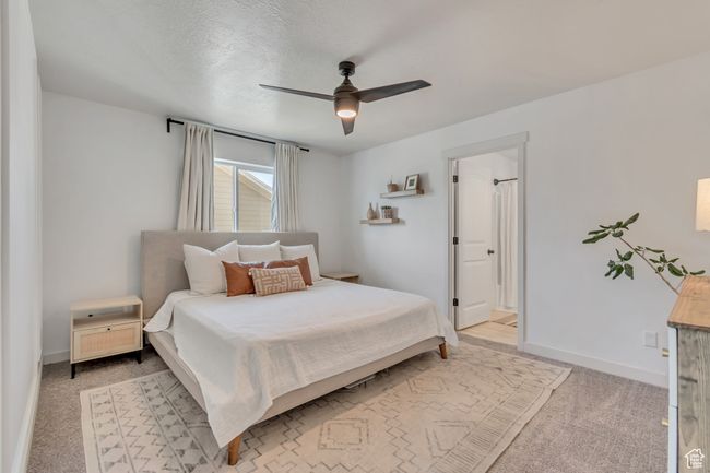 Bedroom with light colored carpet and a ceiling fan | Image 11