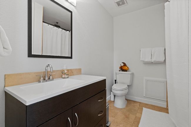 Full bathroom featuring toilet, tile patterned flooring, vanity, and baseboards | Image 23