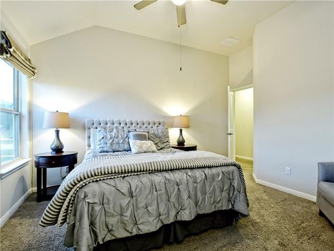 Bedroom with carpet floors, vaulted ceiling, and ceiling fan | Image 15
