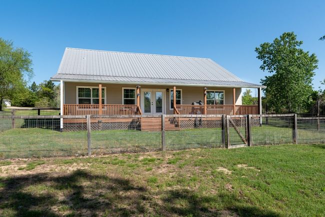 Back of property with a yard, metal roof, french doors, and a gate | Image 5