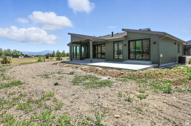 Rear view of house featuring a patio and a mountain view | Image 54