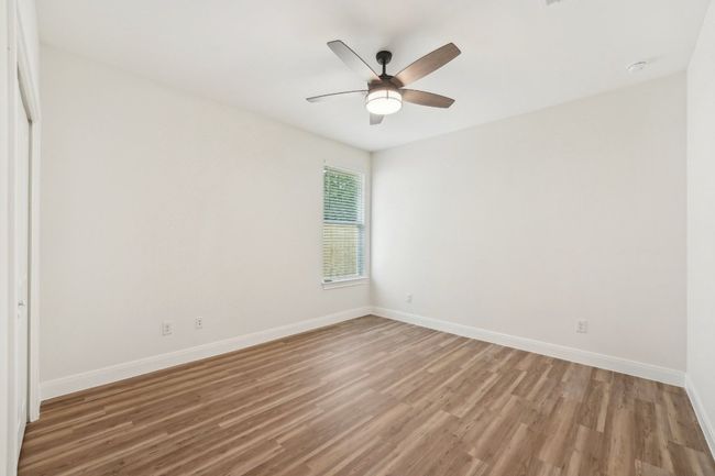 Bedroom 3 with baseboards, a ceiling fan, and wood plank vinyl floor | Image 30