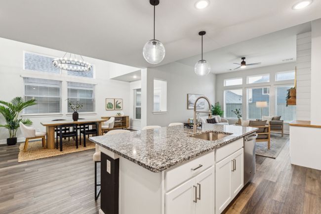Kitchen with a sink, open floor plan, light wood-type flooring, a ceiling fan, and dishwasher | Image 5
