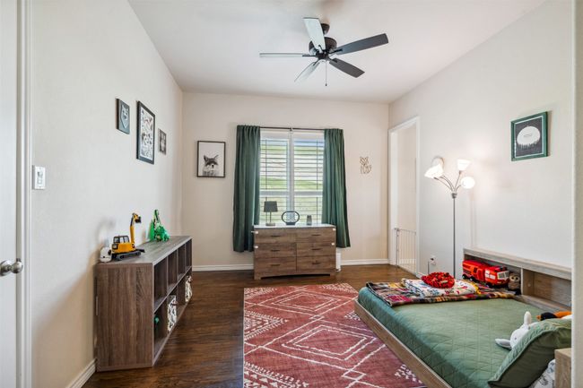 Bedroom featuring dark wood-type flooring and baseboards | Image 24