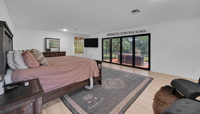 Bedroom featuring access to exterior, wood finished floors, and a sliding glass door | Image 15