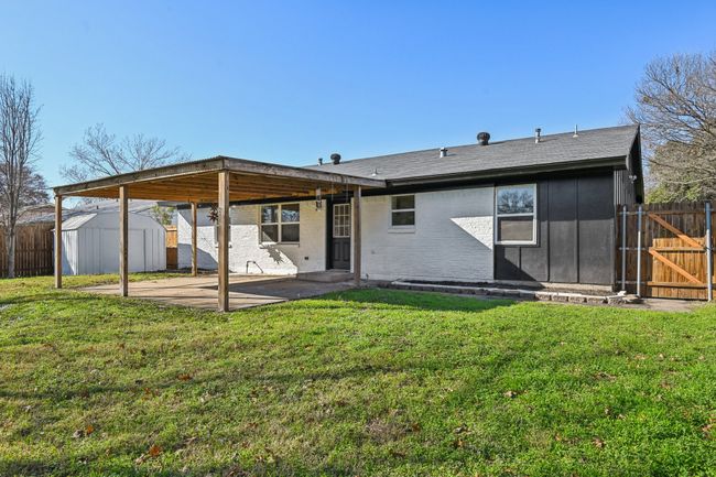 Back of property with a patio area, a gate, and brick siding | Image 24