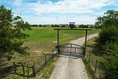 View of gate featuring a yard and a rural view | Image 1