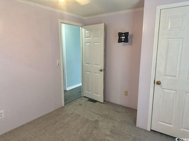 Unfurnished bedroom featuring carpet floors and crown molding | Image 22
