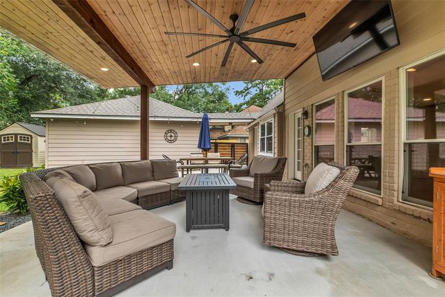 Seller added a large custom patio with wood shiplap ceiling and oversized fan. | Image 35