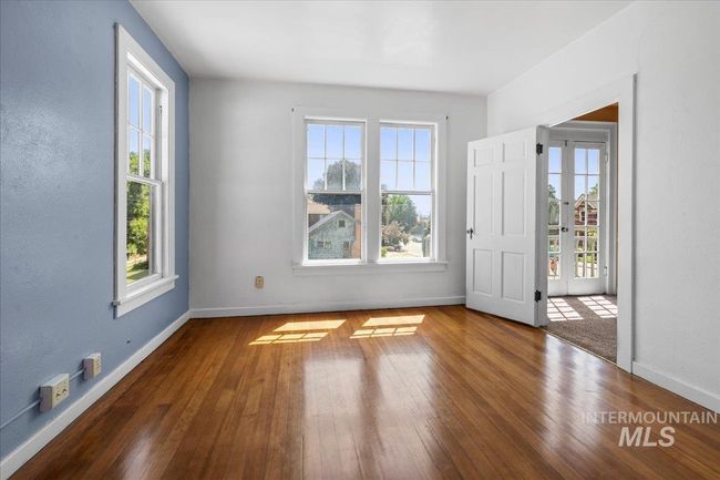 Unfurnished room featuring plenty of natural light and wood-type flooring | Image 39
