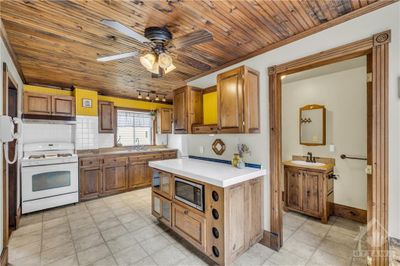 Spacious kitchen with beautiful wood details. Main floor powder room and laundry | Image 2