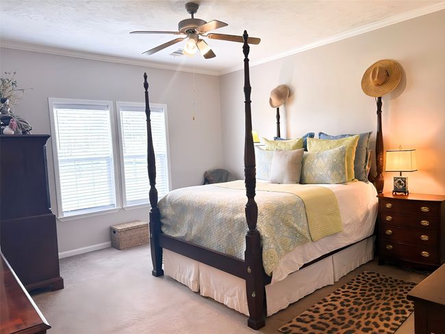 Carpeted bedroom featuring crown molding, baseboards, and ceiling fan | Image 25
