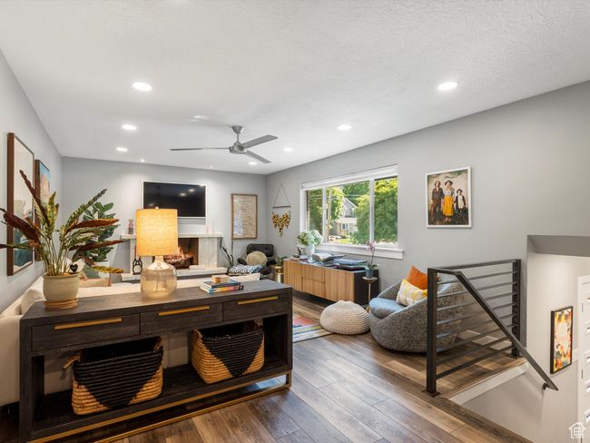 Office area featuring wood-type flooring, a ceiling fan, recessed lighting, and a warm lit fireplace | Image 7