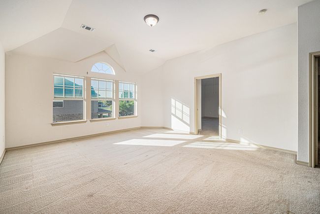 Empty room with carpet flooring, lofted ceiling, and baseboards | Image 19