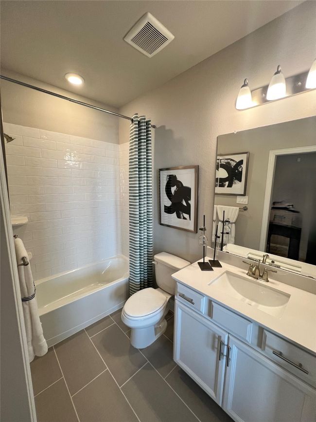 Bathroom featuring vanity, shower / tub combo with curtain, tile patterned floors, and recessed lighting | Image 13