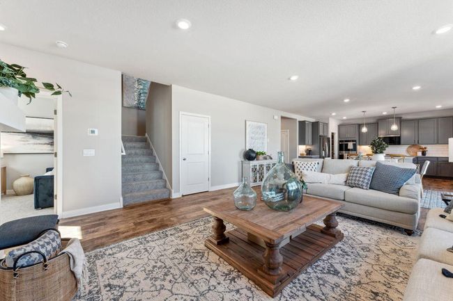Switch back stairs lead to four bedrooms, a loft and laundry room upstairs. Photo of model home, colors and finishes will vary. | Image 16