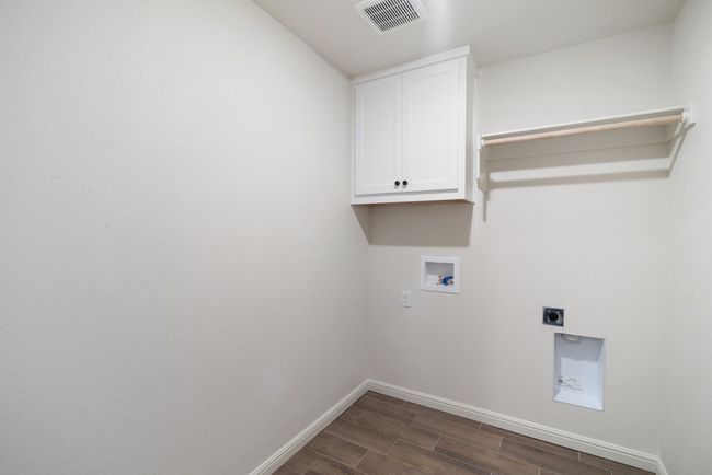 Laundry room with hookup for an electric dryer, cabinets, and washer hookup | Image 23