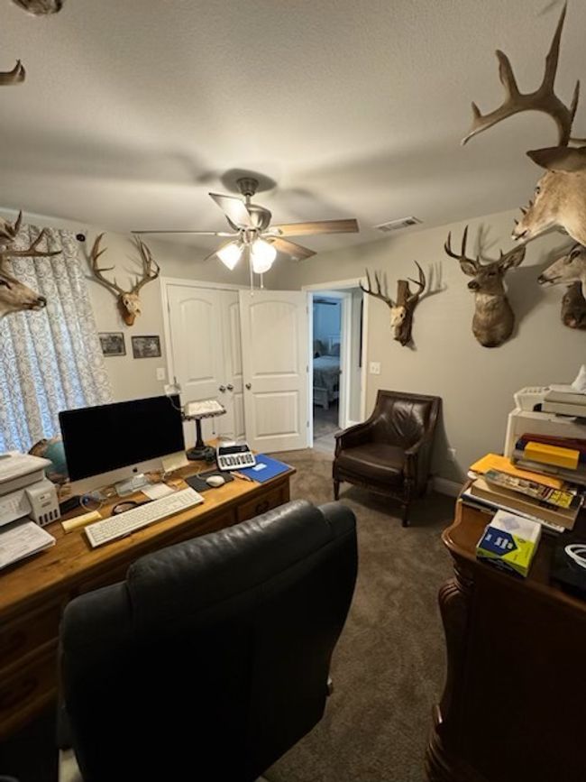 Carpeted home office with visible vents and a ceiling fan | Image 4