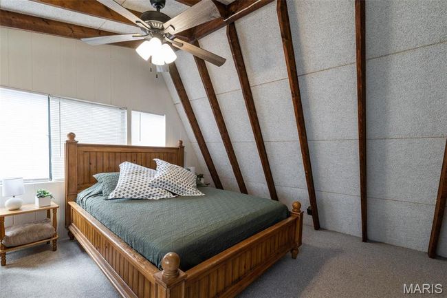 Bedroom featuring lofted ceiling with beams and carpet floors | Image 45