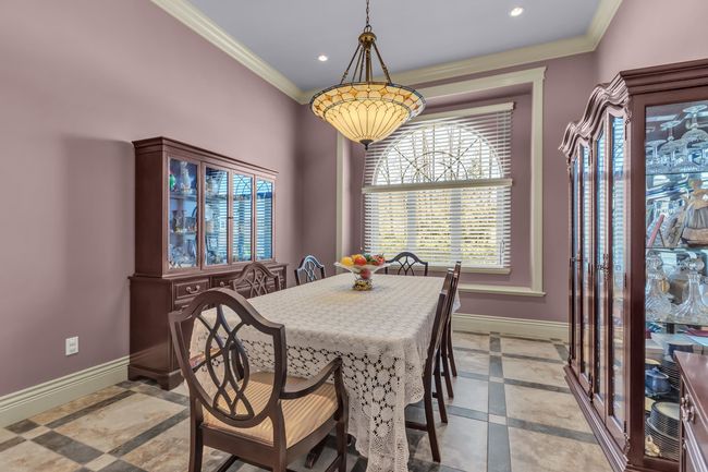 Dining room featuring inlaid floor details, baseboards, ornamental molding, and recessed lighting | Image 9