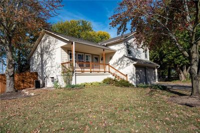 View of front of home featuring a front lawn, covered porch, and a garage | Image 3