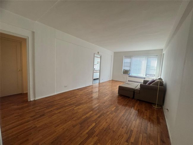 Living room featuring wood-type flooring, cooling unit, and baseboards | Image 5