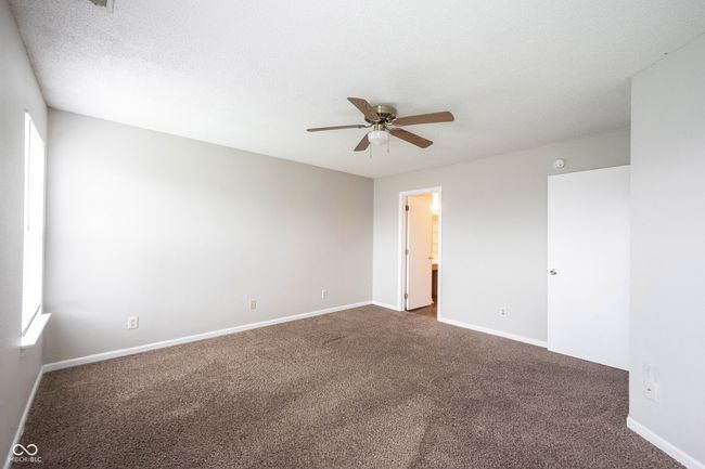 empty room with ceiling fan, baseboards, and dark colored carpet | Image 31