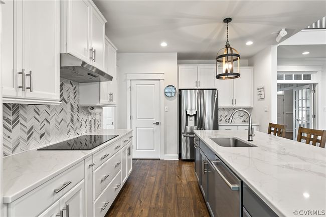 Kitchen featuring pendant lighting, dark hardwood / wood-style floors, and white cabinets | Image 15